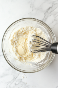 flour-and-other-dry-ingredients-being-gradually-mixed-into-the-butter-mixture-to-form-the-cookie-dough