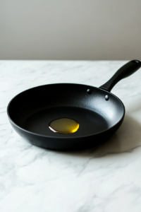 This image shows a pan being heated on the stove, ensuring it reaches the ideal temperature for searing the marinated chicken.