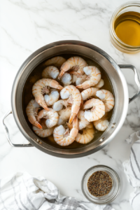 This image shows a large pot filled with water on a stovetop, heating up to the perfect temperature for boiling fresh shrimp, setting the stage for a flavorful seafood dish.