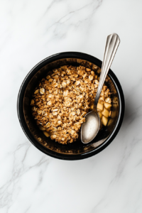 This image shows the apple crisp resting after cooking in the crockpot, allowing the flavors to settle before serving a warm, delicious portion.