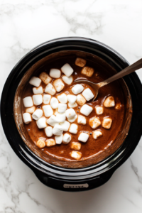 This image shows marshmallows resting on the surface of the hot chocolate, slowly melting into the drink to create a creamy and indulgent finish.