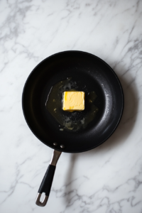 This image shows butter melting in a skillet, the first step in creating a rich, flavorful base for the crockpot green beans.