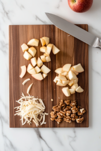 This image shows fresh apples being peeled and chopped into small pieces, preparing them for slow cooking into a smooth and flavorful applesauce.