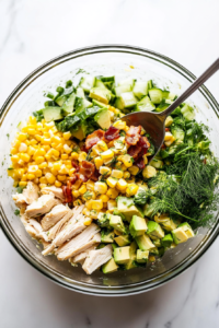 This image shows a small bowl with freshly squeezed lemon juice, olive oil, and seasonings being whisked together to create a zesty dressing.