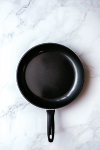 This image shows a skillet with hot oil, ready for searing the chicken to create a flavorful crust.