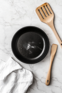 This image shows a spatula transferring the stir-fried vegetables from the pan onto a plate, making space for the next step in the Chicken and Vegetables Stir Fry preparation.