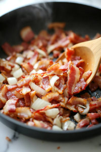 This image shows sliced mushrooms being sautéed in a pan, turning golden brown and releasing their earthy aroma, adding depth to the dish.