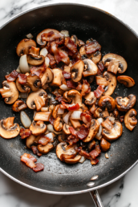 This image shows golden-browned chicken pieces being returned to the pan, ready to soak up the delicious sauce before baking.