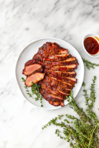 This image shows a sharp knife slicing through the smoked turkey pastrami, revealing its juicy, tender interior and flavorful crust, ready to be served.