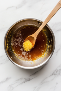 This image shows the sauce ingredients being mixed together in a saucepan, ready to be simmered to create a flavorful dressing for the fruit salad.