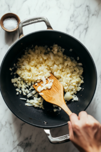 cooking-finely-chopped-onions-with-salt-and-ginger-garlic-paste-for-a-deep-caramelized-flavor