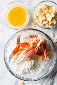 This image shows crab meat being carefully dredged in flour, dipped into an egg wash, and then coated in crushed saltine crackers, creating a crispy and flavorful exterior before frying.