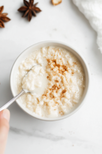 letting-rice-pudding-cool-before-serving-in-a-white-bowl-with-cinnamon-sprinkle