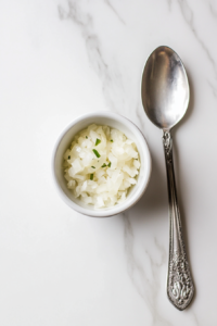 This image shows onions and garlic being microwaved in a bowl, softening them for the BBQ sauce preparation.