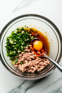 This image shows freshly prepared wontons and chopped vegetables being added to the bubbling pot of broth, infusing the soup with rich flavors.