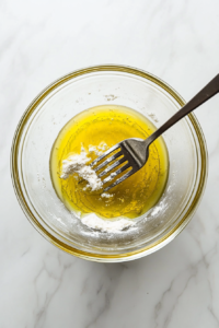 mixing-flour-with-oil-in-a-large-bowl-to-form-the-base-for-the-tortilla-dough