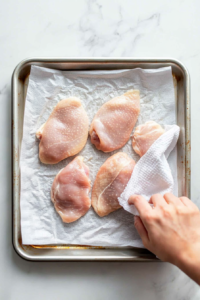 preparing-chicken-thighs-on-a-baking-sheet-2