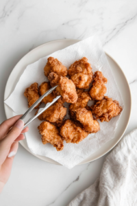 This image shows Karaage chicken resting again after the second fry, ensuring it stays crispy and juicy.