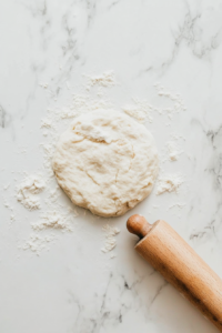 rolling-each-dough-portion-into-an-8-inch-round-tortilla