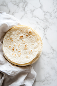 stacking-the-cooked-tortillas-with-a-dishcloth-to-keep-them-warm-and-soft