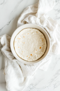 transferring-the-cooked-tortilla-to-a-dishcloth-to-keep-warm