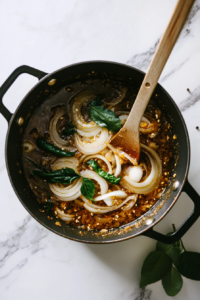 sauteing-onions-masala-heavy-bottomed-pot-white-marble